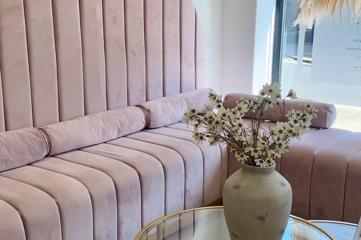 The soft pink lounge seating in the SYN. clinic reception